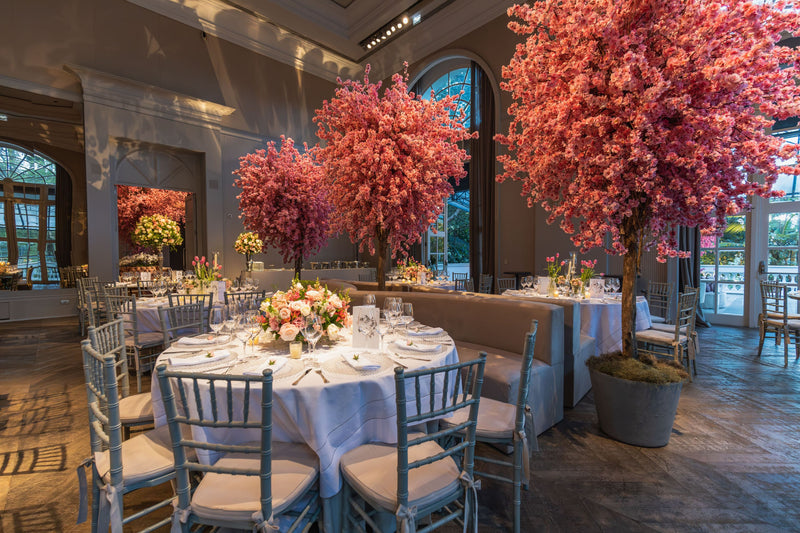 Large artificial cherry blossom tree in a restaurant, event, or private dining setting